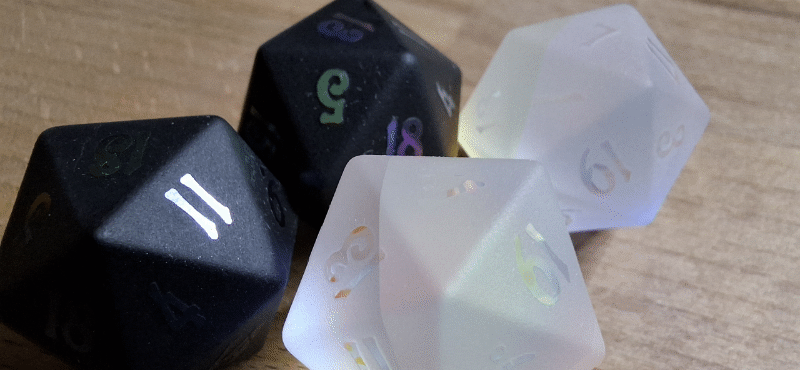 My beautify d20s, two black, and two matching white. All of them glitter like rainbows in light. Since I&rsquo;m playing other systems than D&D I don&rsquo;t know how much use they&rsquo;ll be